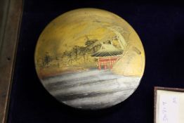 A Chinese circular lacquer box and cover.