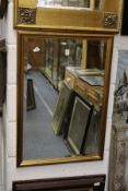 A gilt framed mirror.