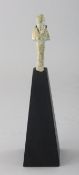 AN EGYPTIAN ANTIQUITY on a wooden stand. 2.75ins.