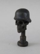 A SMALL BRONZE SKULL PIPE TAMPER. 1.5ins.