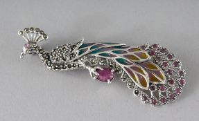 A SILVER, RUBY, PLIQUE ENAMEL PEACOCK BROOCH.