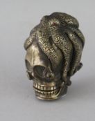 A CAST BRASS SKULL VESTA. 2ins.