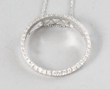 AN 18CT WHITE GOLD AND DIAMOND (0.39cts) CIRCLE PENDANT on a chain.
