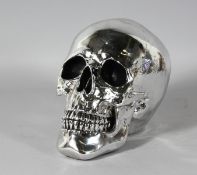 A SILVERED SKULL. 8ins high.