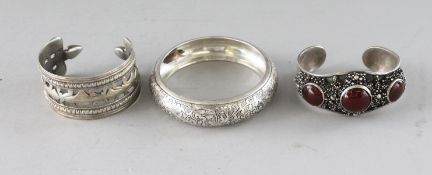 THREE ISLAMIC SILVER BANGLES.