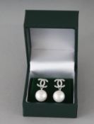 A PAIR OF CHANEL DESIGN SILVER AND PEARL DOUBLE C EARRINGS.