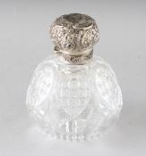 A LARGE VICTORIAN CUT GLASS SCENT BOTTLE with silver band and repousse top. London 1890. Maker: