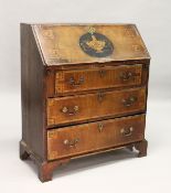 A GEORGE III MAHOGANY AND INLAID BUREAU, with a fall flap over three drawers, on bracket feet. 2ft