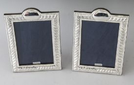 A PAIR OF SILVER PHOTOGRAPH FRAMES. 7.5ins x 5.25ins.