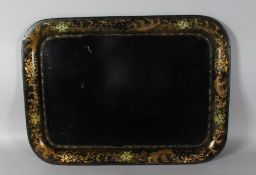 A VICTORIAN RECTANGULAR TOLEWARE TRAY, gilt decorated border, painted with flowers. 26ins wide.