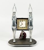 AN ART DECO CHROME PLATED ELECTRIC MANTLE CLOCK, by Genalex, with a square dial suspended between