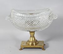 A GOOD HOBNAIL CUT BOAT SHAPED BASIN, with curling handles, on a brass base with claw feet. 9.5ins