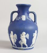 A BLUE JASPER WARE TWO HANDLED PORTLAND VASE. 7.5ins high.