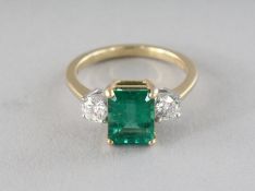 A SUPERB 18CT GOLD THREE-STONE EMERALD AND DIAMOND RING.