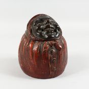 A CONTINENTAL POTTERY TOBACCO JAR AND COVER, modelled as a woman wearing a headscarf. Impressed