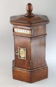 A GOOD MAHOGANY OCTAGONAL POST BOX in the Victorian style, with letter box and front door.
