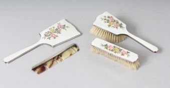 A FOUR PIECE SILVER AND ENAMEL DRESSING TABLE SET, mirror, two brushes and comb. Birmingham 1941.
