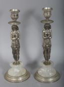 A PAIR OF PLATED AND ROCK CRYSTAL EGYPTIAN FIGURAL CANDLESTICKS on circular bases.