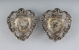A PAIR OF SILVER PIERCED HEART SHAPED BONBON DISHES.