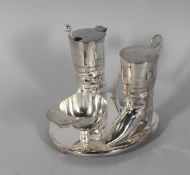 A SILVER PLATE HUNTING THREE PIECE CONDIMENT, pair of boots and a cap.