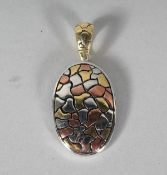 A SILVER ABSTRACT OVAL PENDANT shaped as a turtle.