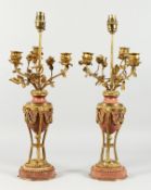 A VERY GOOD PAIR OF REGENCY, ORMOLU AND MARBLE URN SHAPED THREE BRANCH CANDELABRA, mounted with rams