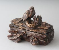 A GOOD SMALL BLACK FOREST CARVED WOOD JEWELLERY BOX formed as a dog with a bird and oak leaves. 6.