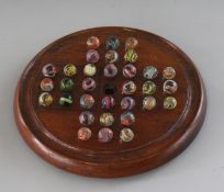 A SMALL SOLITAIRE BOARD, 8ins diameter, and marbles.