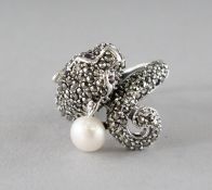 A SILVER, MARCASITE, PEARL AND RUBY EYE PANTHER RING.