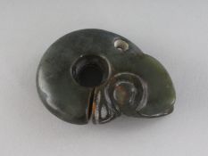 A CARVED JADE AMULET, a 