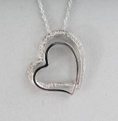 A 9CT GOLD DIAMOND SET HEART PENDANT on a chain.