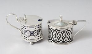 TWO PIERCED MUSTARD POTS with sapphire blue liners. Birmingham 1902 and Chester 1899.