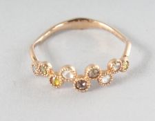 AN 18CT YELLOW GOLD NINE STONE MIXED COLOUR DIAMOND ETERNITY RING.