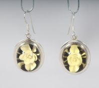 A PAIR OF SILVER FLOWER EARRINGS.