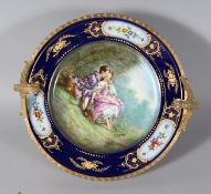 A GOOD SEVRES PORCELAIN PLATE, painted by E. FROGE, of young lovers. 10ins diameter, in an ormolu