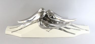 A LEJAN POTTERY GROUP with three silvered swallows and cream base, 1929. 19ins long.