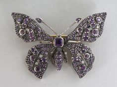 A 9CT GOLD, SILVER SET, AMETHYST AND DIAMOND BUTTERFLY BROOCH.