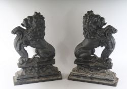 A PAIR OF CAST IRON RAMPANT LION DOOR STOPS. 14ins high.