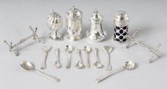 FOUR VARIOUS SALT AND PEPPERS, NINE SALT SPOONS AND A PAIR OF KNIFE RESTS.