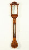 A GOOD VICTORIAN OAK CASED STICK BAROMETER by J. HUGHES, LONDON, with ivory in an architectural