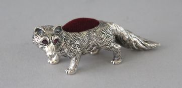 A SILVER RUBY EYE FOX PIN CUSHION. 2.5ins.