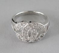 A CHANEL DESIGN SILVER AND CZ DOUBLE C RING.