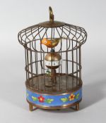 A SINGING BIRD IN A CAGE with cloisonne sides. 7.5ins high.