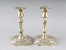 A PAIR OF QUEEN ANNE STYLE CANDLESTICKS on loaded bases. 7ins high. Birmingham 1969.