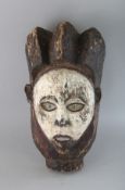 A PAINTED CARVED WOOD TRIBAL MASK. 14ins.