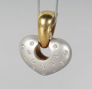 A TWO-COLOUR GOLD DIAMOND SET HEART SHAPED PENDANT.