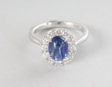 A SUPERB PLATINUM CABOCHON BLUE SAPPHIRE RING, 1,94cts, surrounded by diamonds, 0.57cts.