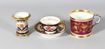 A DERBY CUP AND SAUCER, A CLARET GROUND MUG and A SPODE SPILL VASE.