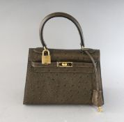 A SMALL BROWN CROCODILE DESIGN BAG. 7.5ins wide.