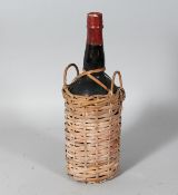 WILLIAMS & HUMBERT LTD., a bottle of sherry in a wicker bottle holder.